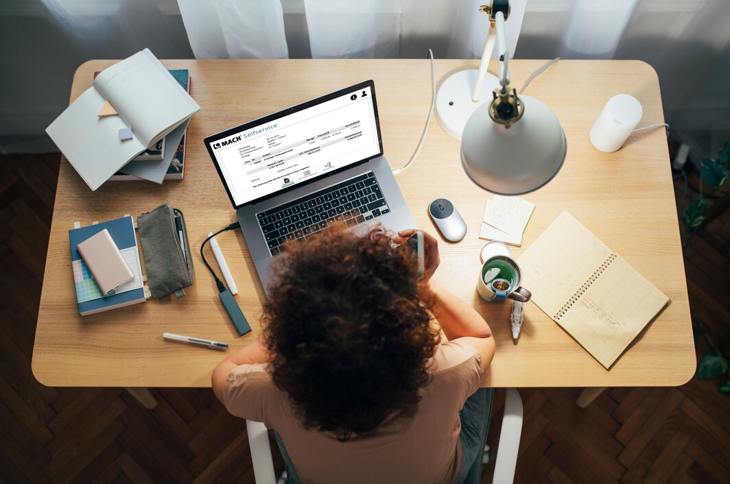 Person arbeitet mit MACH Selfservices im Homeoffice